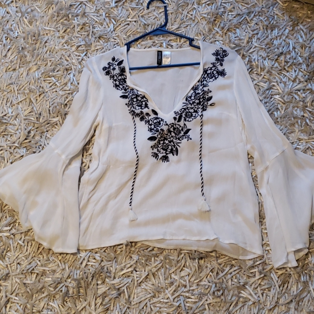 White linen blouse with bell sleeves and navy embr